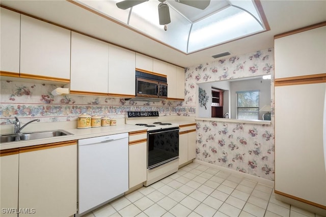 kitchen with white cabinetry, white appliances, sink, and light tile patterned floors