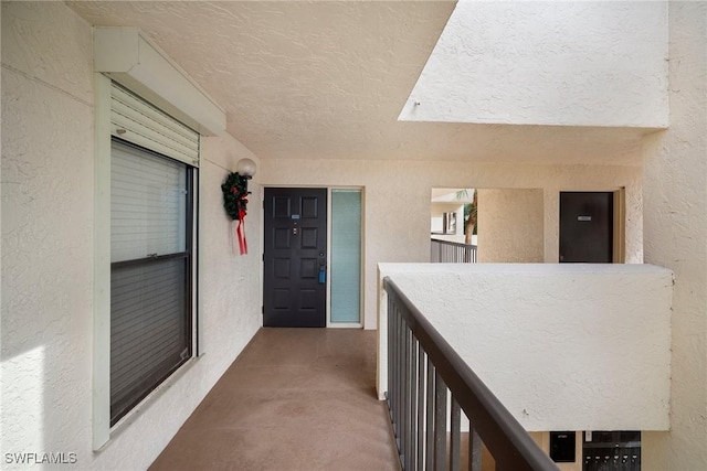 hall featuring a textured ceiling