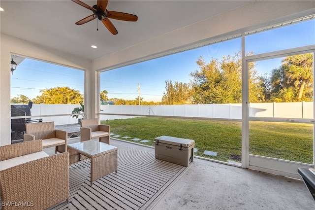 sunroom / solarium featuring ceiling fan