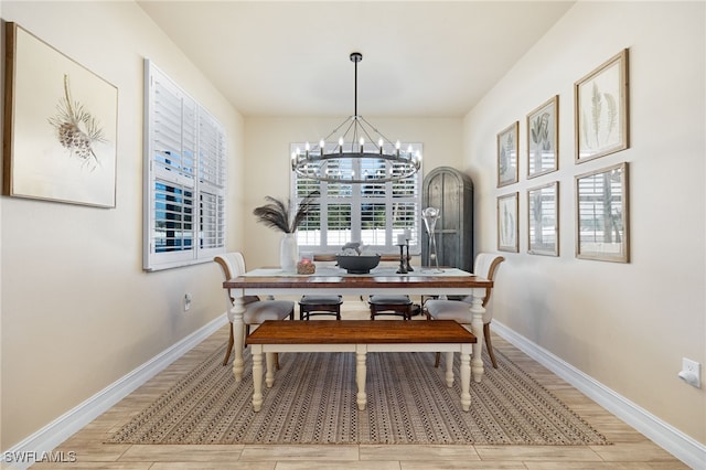 dining space with a chandelier and light wood-type flooring