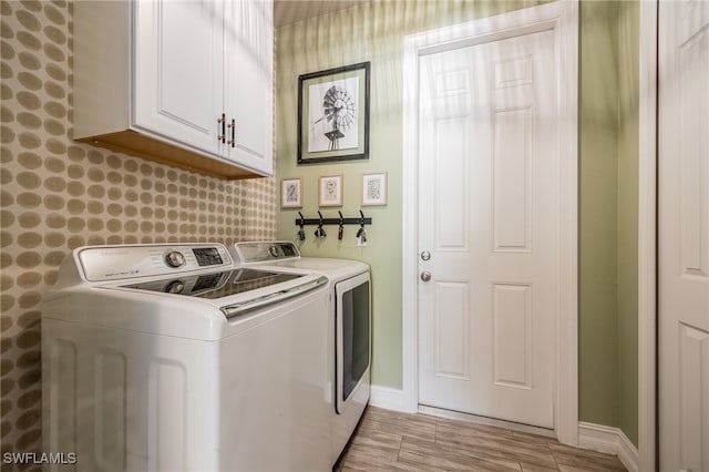 laundry area with cabinets and washer and clothes dryer