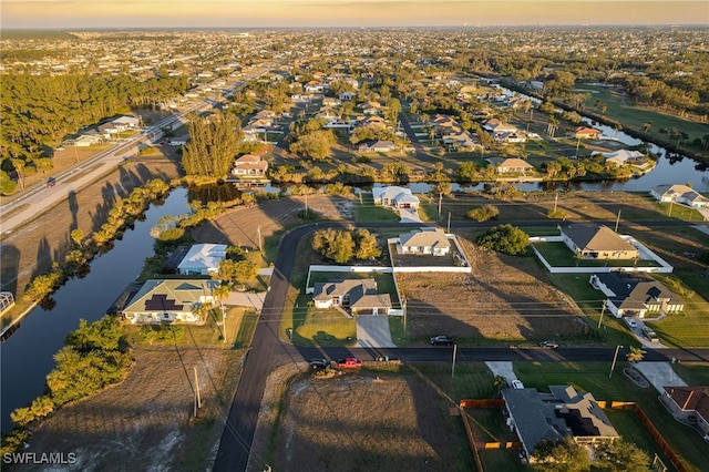 aerial view at dusk with a water view