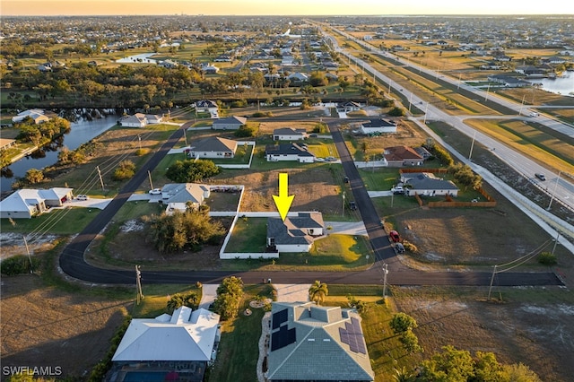 aerial view at dusk with a water view