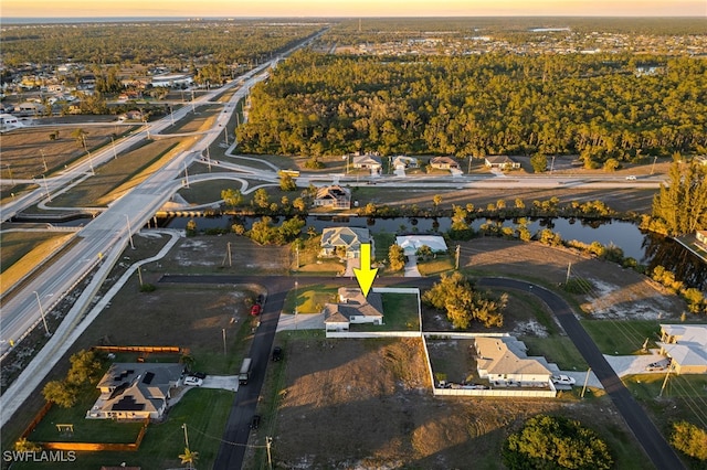 aerial view at dusk with a water view