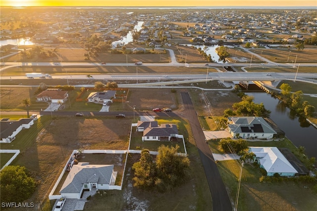 aerial view at dusk with a water view