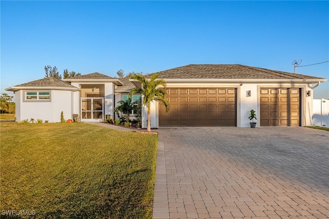 view of front of property with a front yard and a garage