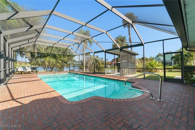 view of pool featuring glass enclosure and a patio area