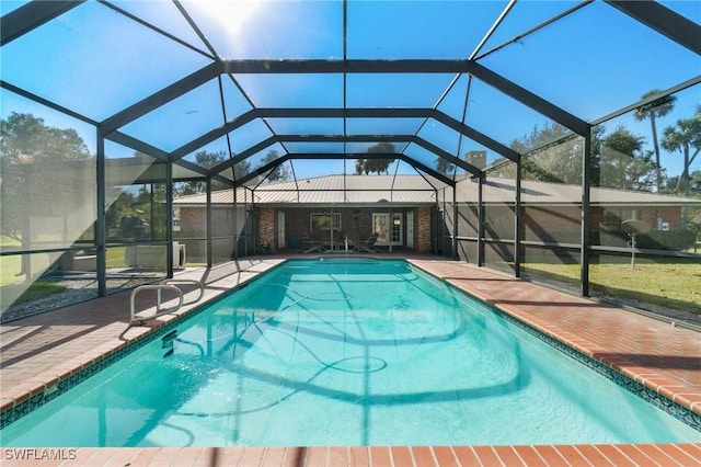 view of swimming pool with glass enclosure and a patio