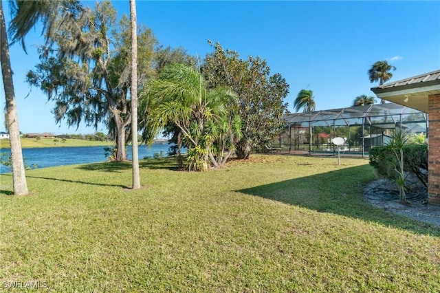 view of yard featuring a water view and a lanai