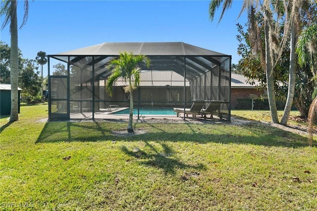 exterior space featuring a yard and glass enclosure