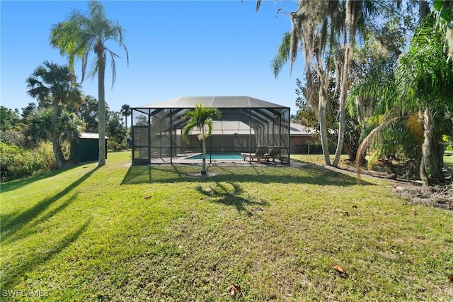 view of yard with a lanai and a shed