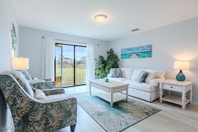 living room with light hardwood / wood-style flooring