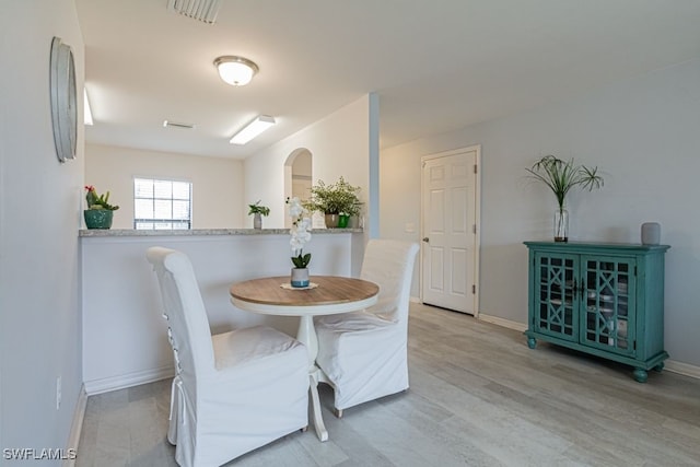 dining space with light wood-type flooring