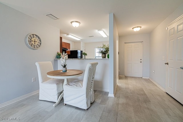 dining area with light hardwood / wood-style floors