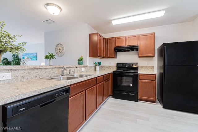 kitchen with kitchen peninsula, sink, and black appliances