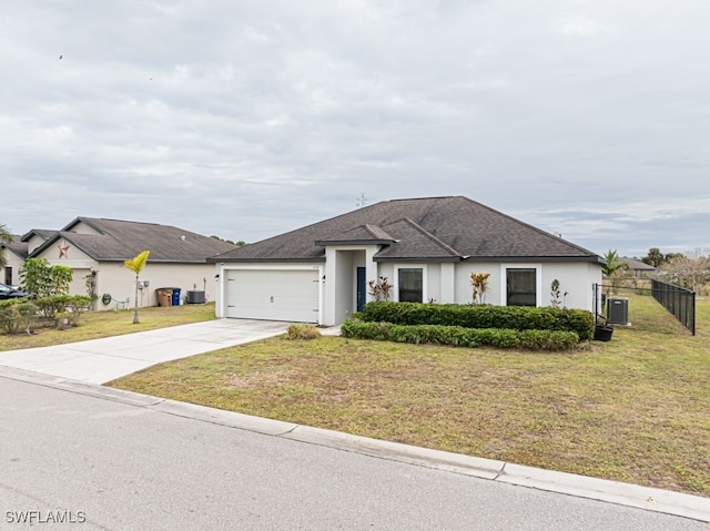 view of front of house with central AC, a garage, and a front lawn