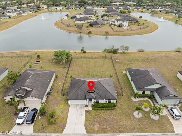 birds eye view of property featuring a water view