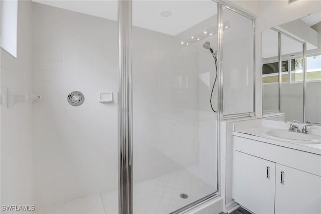 bathroom featuring vanity and tiled shower