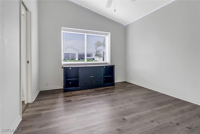 unfurnished room with ceiling fan, lofted ceiling, and wood-type flooring