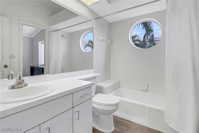 full bathroom with vanity, wood-type flooring, shower / bath combo, and toilet