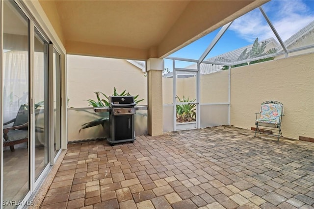 view of patio / terrace featuring a grill and a lanai