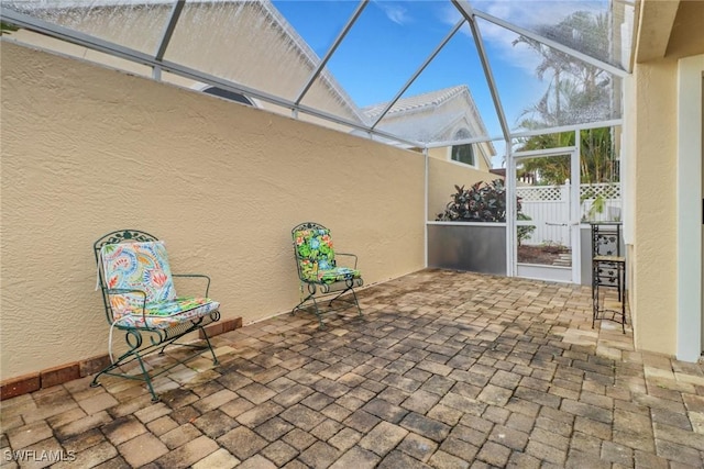 view of patio with glass enclosure