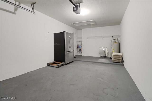 garage featuring stainless steel refrigerator, a garage door opener, and electric water heater