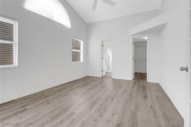 interior space featuring a spacious closet, high vaulted ceiling, light hardwood / wood-style flooring, a closet, and ceiling fan