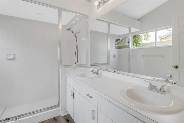 bathroom featuring vanity, wood-type flooring, lofted ceiling, and walk in shower