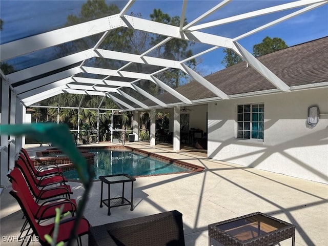 view of swimming pool featuring a lanai and a patio