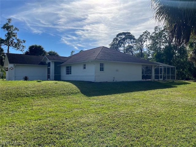 view of side of home with a lawn