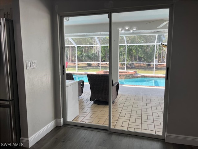 doorway to outside featuring hardwood / wood-style floors and ceiling fan