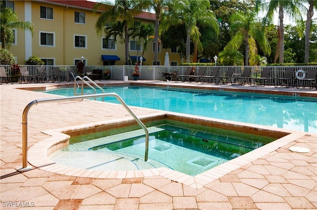 view of swimming pool featuring a community hot tub