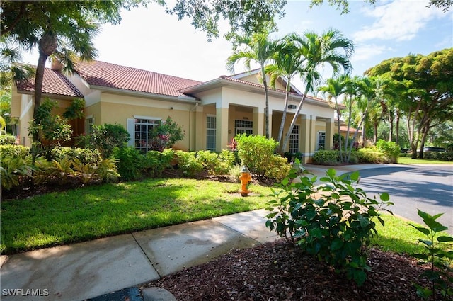 mediterranean / spanish-style home featuring a front lawn