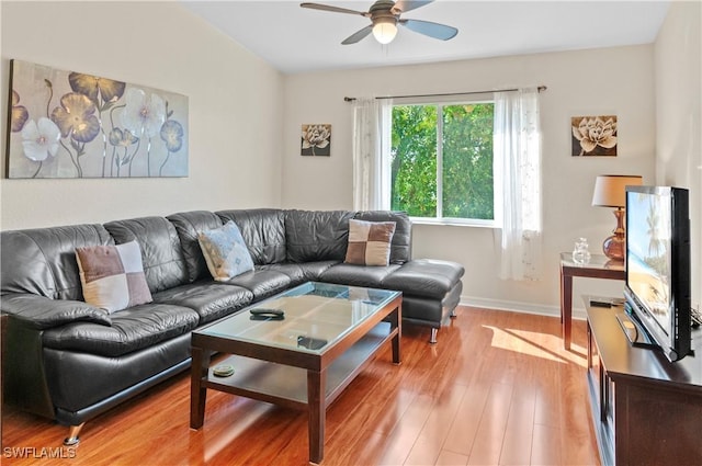 living room with hardwood / wood-style flooring and ceiling fan