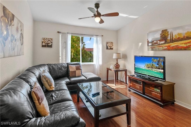 living room featuring ceiling fan and wood-type flooring