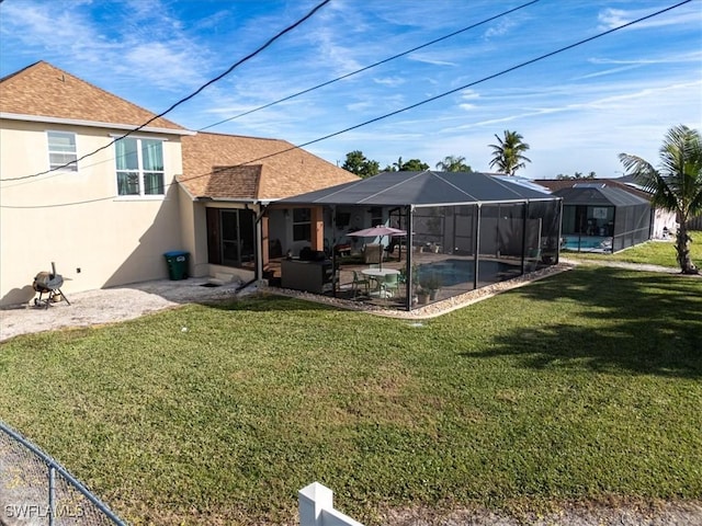 back of house with a lawn, glass enclosure, a patio area, and a pool