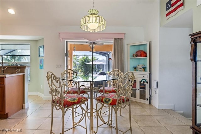 dining space with ceiling fan and light tile patterned flooring