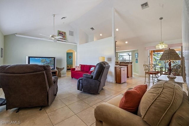 tiled living room featuring ceiling fan and high vaulted ceiling