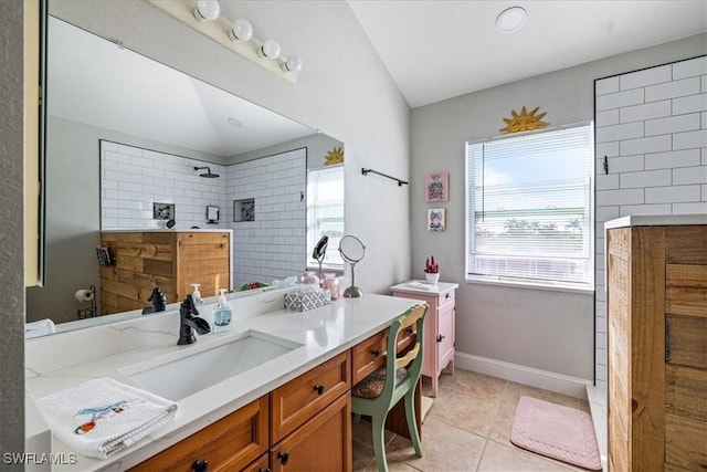 bathroom with tile patterned flooring, vanity, lofted ceiling, and walk in shower