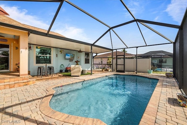 view of pool with a patio and glass enclosure