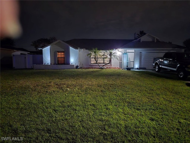 view of front of property featuring a lawn and a garage