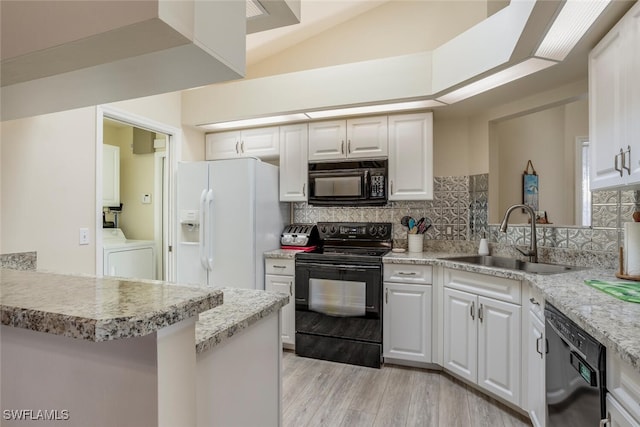 kitchen featuring white cabinets, sink, kitchen peninsula, and black appliances