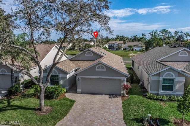 view of front of home with a front yard and a garage