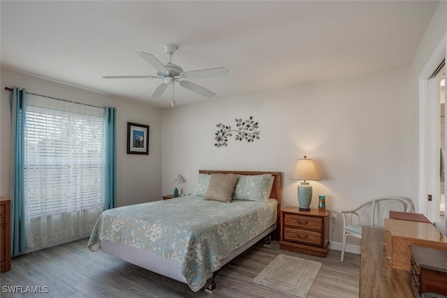 bedroom with hardwood / wood-style flooring and ceiling fan