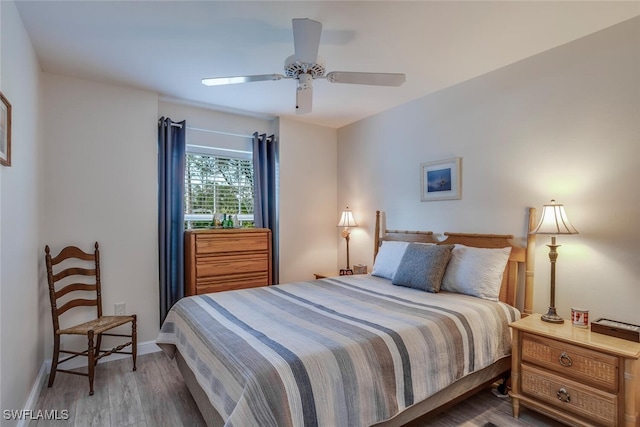 bedroom featuring ceiling fan and dark hardwood / wood-style floors