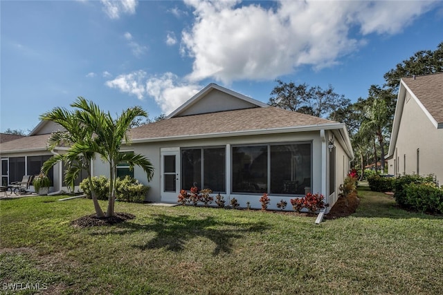 rear view of property with a lawn