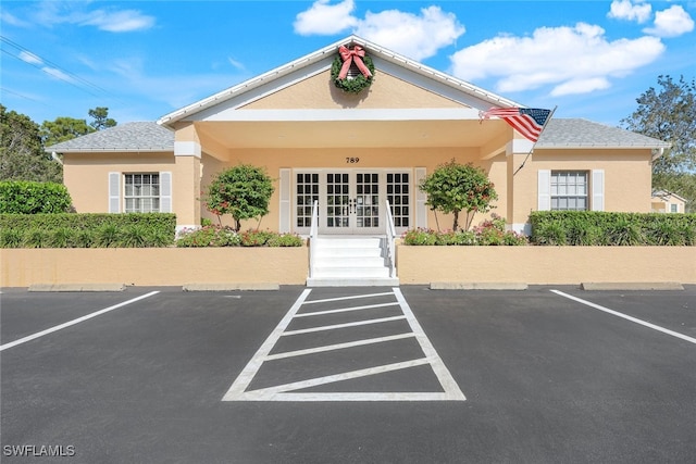 651 Wiggins Lake Dr Unit 101, Naples, FL 34110 - view of property featuring uncovered parking