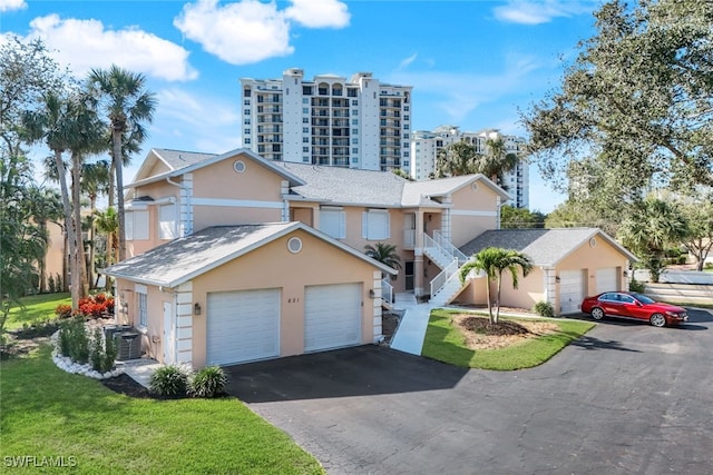 view of front property featuring central AC and a garage