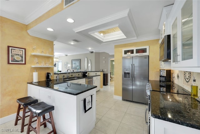651 Wiggins Lake Dr Unit 101, Naples, FL 34110 - kitchen featuring stainless steel appliances, a peninsula, crown molding, a kitchen bar, and light tile patterned floors